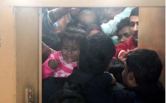 भगदड़ के दौरान ट्रेन में हर हाल में चढ़ने की आपाधापी की कहानी बयां करती तस्वीर।